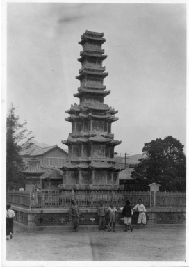A photograph of the Wongaksa Pagoda in Tapgol Park (previously Pagoda Park) in Seoul, South Korea (Called Keijo under Japanese rule). Some Korean children are posing in front of the Pagoda.